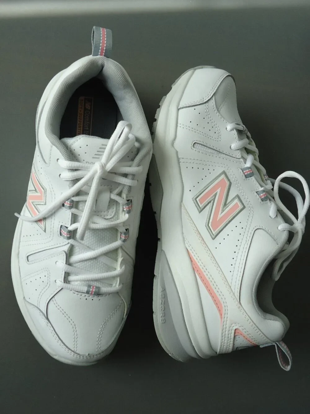 SIZE 9.5. D. New Balance women's white leather sneakers shoes.